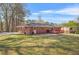 Expansive backyard featuring a well-maintained lawn, a brick house, and a lovely deck, perfect for outdoor enjoyment at 4218 Hideaway Dr, Tucker, GA 30084