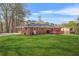 Expansive backyard featuring a well-maintained lawn, a brick house, and a lovely deck, perfect for outdoor enjoyment at 4218 Hideaway Dr, Tucker, GA 30084