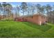 Spacious backyard with lush lawn, mature trees, and a red deck, ideal for outdoor entertaining and relaxation at 4218 Hideaway Dr, Tucker, GA 30084