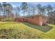 Spacious backyard with lush lawn, mature trees, and a red deck, ideal for outdoor entertaining and relaxation at 4218 Hideaway Dr, Tucker, GA 30084