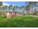 Quaint brick home with a large front yard and mature trees at 4218 Hideaway Dr, Tucker, GA 30084