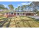 Well-maintained red brick home with mature trees and a lush green lawn at 4218 Hideaway Dr, Tucker, GA 30084