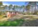 Quaint brick home with a large front yard and mature trees at 4218 Hideaway Dr, Tucker, GA 30084