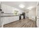 Spacious kitchen features white cabinets, stainless appliances, and laminate flooring at 4218 Hideaway Dr, Tucker, GA 30084