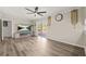 Bright living room with laminate flooring, sliding doors to patio, and a contemporary ceiling fan at 4218 Hideaway Dr, Tucker, GA 30084