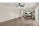 Spacious living room featuring new flooring, neutral walls, a ceiling fan, and sliding glass doors at 4218 Hideaway Dr, Tucker, GA 30084
