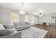 Bright living room featuring neutral tones, laminate flooring, and a modern chandelier at 4218 Hideaway Dr, Tucker, GA 30084