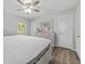 Bright main bedroom featuring neutral walls, a ceiling fan, and laminate flooring at 4218 Hideaway Dr, Tucker, GA 30084