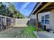 Enclosed backyard featuring a small patio and a wooden fence for added privacy at 5264 Mill Way, Stone Mountain, GA 30083