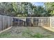 Fenced backyard with a grassy lawn and a view of mature trees offering privacy at 5264 Mill Way, Stone Mountain, GA 30083