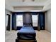 Bedroom with plush carpet, a tray ceiling, and natural light offers a serene living space at 5264 Mill Way, Stone Mountain, GA 30083