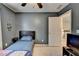 Well-lit bedroom showcasing neutral carpet, ceiling fan, and dark furniture at 5264 Mill Way, Stone Mountain, GA 30083