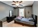 Cozy bedroom with gray walls, ceiling fan, and large window for natural light at 5264 Mill Way, Stone Mountain, GA 30083