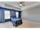 Bedroom with plush carpet, a tray ceiling, and a ceiling fan provides a cozy and stylish retreat at 5264 Mill Way, Stone Mountain, GA 30083