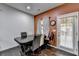 Dining area features a large wooden table, unique lighting and a bright orange wall at 5264 Mill Way, Stone Mountain, GA 30083