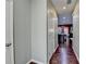 Hallway featuring gleaming hardwood floors with views to the kitchen and living spaces at 5264 Mill Way, Stone Mountain, GA 30083