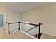 Upstairs landing featuring neutral carpet, white walls, and dark wood banister at 5264 Mill Way, Stone Mountain, GA 30083