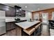 Kitchen with large island and stainless appliances, blending into the living room at 5264 Mill Way, Stone Mountain, GA 30083