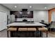 Bright kitchen offers a center island with barstool seating and stainless steel appliances at 5264 Mill Way, Stone Mountain, GA 30083