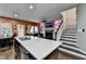 Open-concept kitchen boasts a large island with quartz countertops and stainless steel appliances at 5264 Mill Way, Stone Mountain, GA 30083