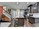 Renovated kitchen featuring stainless steel appliances, dark cabinets and a large center island at 5264 Mill Way, Stone Mountain, GA 30083