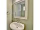Neat powder room featuring neutral paint, stylish mirror, pedestal sink, and brushed nickel hardware at 5264 Mill Way, Stone Mountain, GA 30083