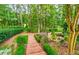 A lush backyard features a brick pathway and vibrant foliage at 6205 Arnall Nw Ct, Acworth, GA 30101