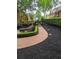 Landscaped backyard with brick paver walkway and manicured hedges at 6205 Arnall Nw Ct, Acworth, GA 30101