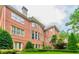 Expansive brick home featuring well-manicured landscaping, multi-pane windows and a charming outdoor patio at 6205 Arnall Nw Ct, Acworth, GA 30101