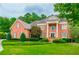 Charming two-story brick home with a meticulously manicured front lawn, enhanced by mature trees at 6205 Arnall Nw Ct, Acworth, GA 30101