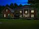 Brick house with multiple windows and a manicured green lawn at dusk at 6205 Arnall Nw Ct, Acworth, GA 30101