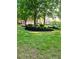 Lush green lawn with mature trees and landscaping adds to the home's curb appeal at 6205 Arnall Nw Ct, Acworth, GA 30101