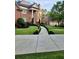 Beautiful brick home showcasing a meticulously landscaped front yard and symmetrical walkway at 6205 Arnall Nw Ct, Acworth, GA 30101
