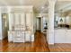 Bright open kitchen with white cabinets, hardwood floors, stone countertops, tile backsplash and stainless double oven at 6205 Arnall Nw Ct, Acworth, GA 30101