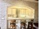 A kitchen with bar seating, granite countertops, custom cabinets and white brick walls at 6205 Arnall Nw Ct, Acworth, GA 30101