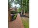 Beautiful brick paver walkway through landscaped backyard at 6205 Arnall Nw Ct, Acworth, GA 30101
