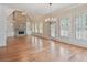 Spacious living room with hardwood floors, stone fireplace, and bright light from the large windows at 6205 Arnall Nw Ct, Acworth, GA 30101