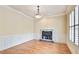 Bright living room showcasing hardwood floors, a fireplace, and beautiful natural light from the shuttered windows at 6205 Arnall Nw Ct, Acworth, GA 30101