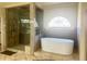 Contemporary bathroom featuring a standalone tub and frameless glass shower, providing a spa-like experience at 6205 Arnall Nw Ct, Acworth, GA 30101