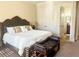 Main bedroom features a King bed, sitting bench, and walk-in closet, offering comfort and style at 6205 Arnall Nw Ct, Acworth, GA 30101