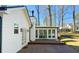 Spacious deck area with a white house exterior surrounded by mature trees and a backyard at 152 Weatherstone Pkwy, Marietta, GA 30068