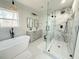 Modern bathroom with a standalone tub, glass-enclosed shower with marble surround, and double vanity sinks at 152 Weatherstone Pkwy, Marietta, GA 30068