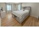 Bedroom featuring hardwood floors, natural light, and a stylish bed creating a welcoming and comfortable retreat at 152 Weatherstone Pkwy, Marietta, GA 30068