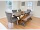 Cozy dining room featuring a rustic wooden table, upholstered chairs, and a bench at 152 Weatherstone Pkwy, Marietta, GA 30068