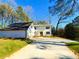 Inviting two-story home with freshly painted white siding, black shutters, and well-manicured lawn at 152 Weatherstone Pkwy, Marietta, GA 30068