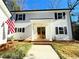 Inviting entryway with a beautiful wood double-door, brick steps, and a charming American flag at 152 Weatherstone Pkwy, Marietta, GA 30068