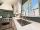 Bright kitchen featuring a stainless steel sink, white cabinets, and views from a large window at 152 Weatherstone Pkwy, Marietta, GA 30068