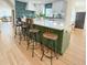 Elegant kitchen island with seating, stainless steel appliances, and hardwood floors at 152 Weatherstone Pkwy, Marietta, GA 30068