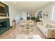 Bright living room with a fireplace, white sofas, a glass coffee table, and an open view of the kitchen at 152 Weatherstone Pkwy, Marietta, GA 30068