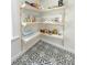 Charming pantry with open shelving, food supplies, and patterned black and white floor tiles at 152 Weatherstone Pkwy, Marietta, GA 30068